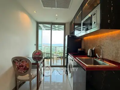 Modern kitchen with balcony view, sleek appliances, and elegant dining area.