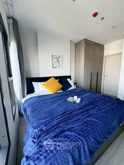 Cozy bedroom with modern design and large window for natural light