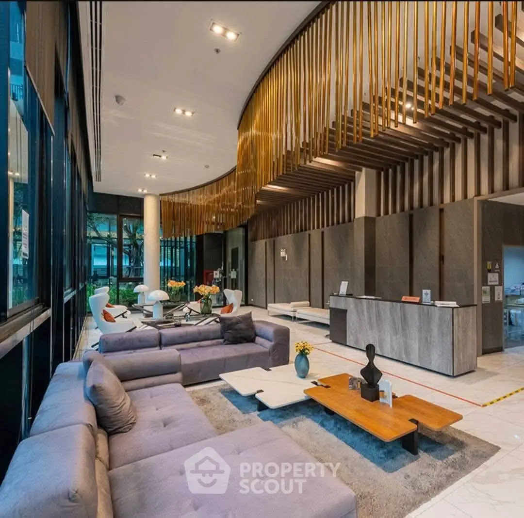 Luxurious modern lobby with elegant seating and stylish decor in a high-end residential building.