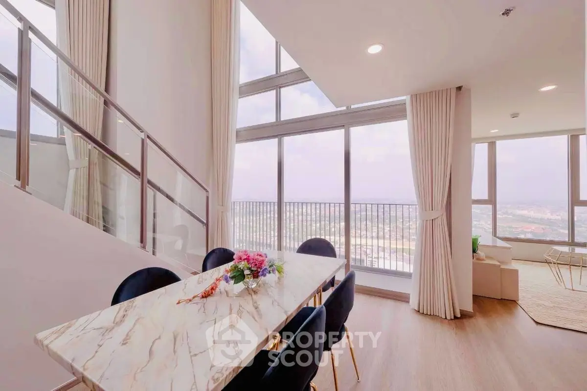 Luxurious high-rise dining area with panoramic city views and elegant marble table.