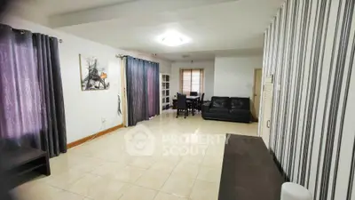 Spacious living room with modern decor and ample natural light