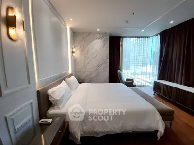 Luxurious modern bedroom with elegant decor and large windows offering natural light.