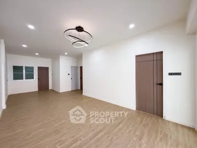 Spacious modern living room with elegant lighting and wooden flooring