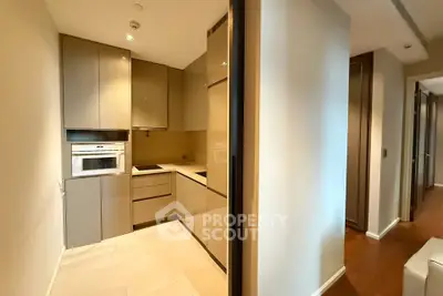 Modern kitchen with sleek cabinetry and built-in oven in a stylish apartment.