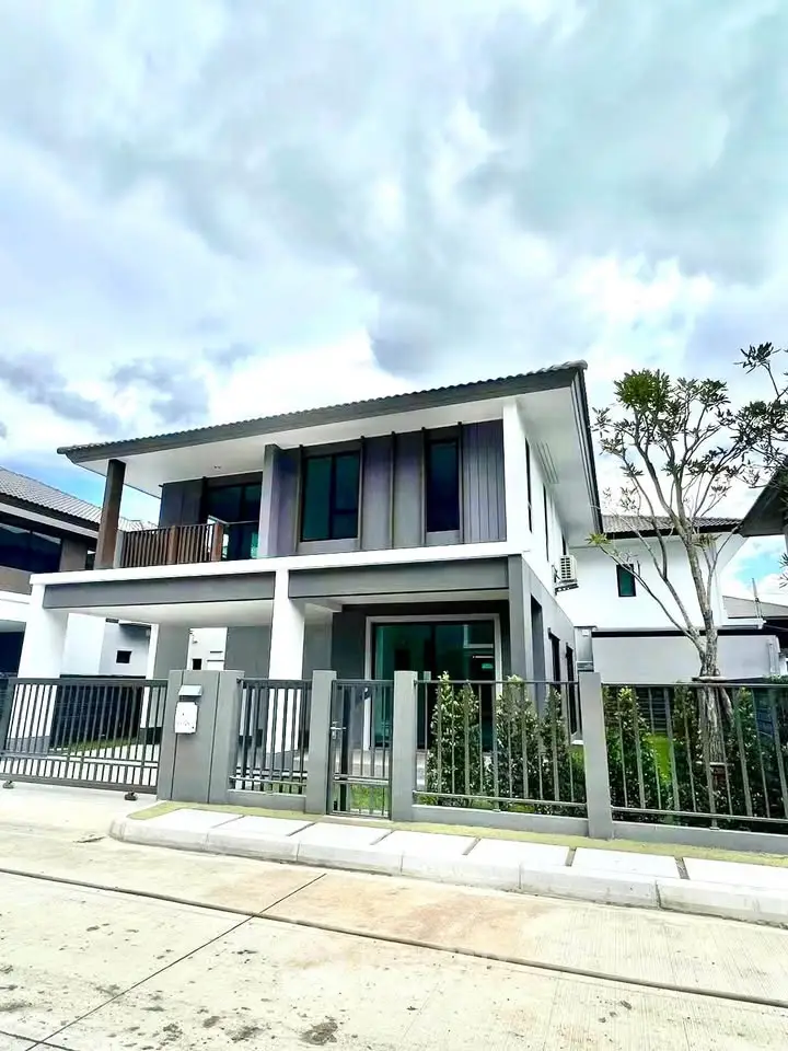 Modern two-story house with sleek design and spacious balcony in a serene neighborhood.
