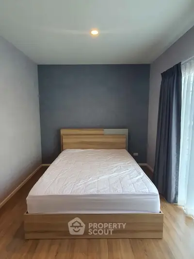 Spacious bedroom with modern wooden bed and natural light