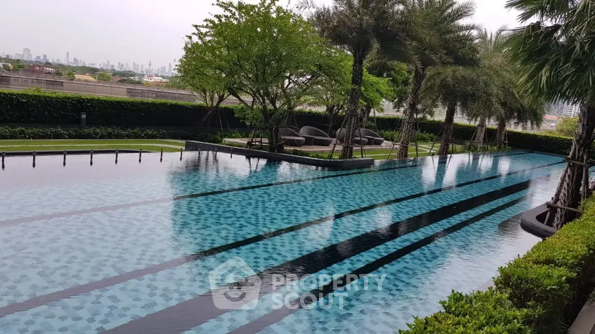 Luxurious outdoor pool with lush greenery and city skyline view