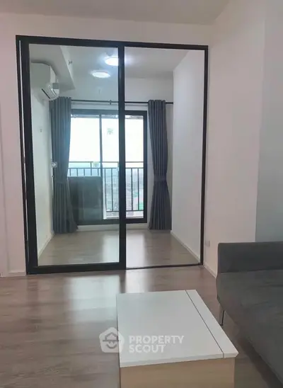 Modern apartment interior with sliding glass doors and balcony view