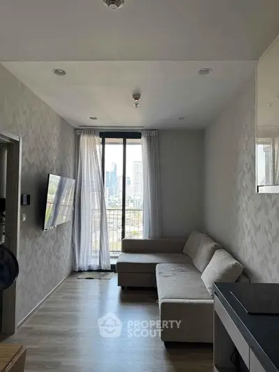 Modern living room with city view, featuring a sleek sofa and wall-mounted TV, perfect for urban living.