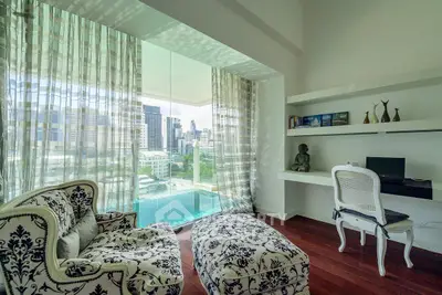 Luxurious study room with elegant armchairs and city view, perfect for productivity and relaxation.