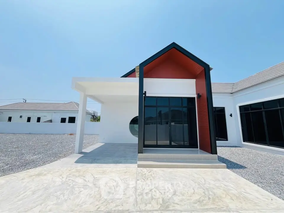 Modern minimalist house with unique architectural design and large windows in a serene neighborhood.