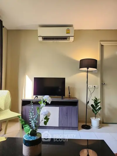 Modern living room with air conditioning, stylish furniture, and natural light.
