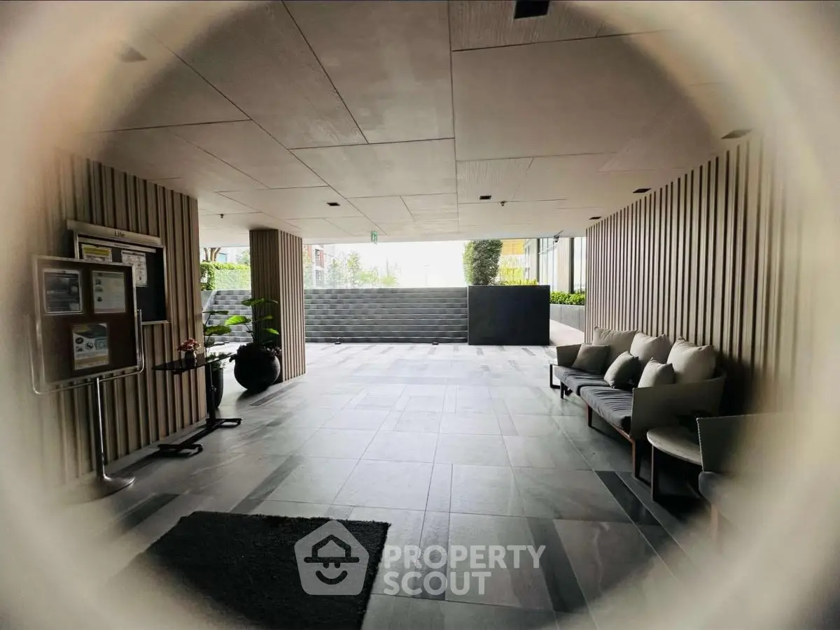 Modern building entrance with stylish seating and sleek design