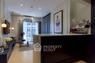 Modern living room with stylish decor and balcony view in a contemporary apartment.