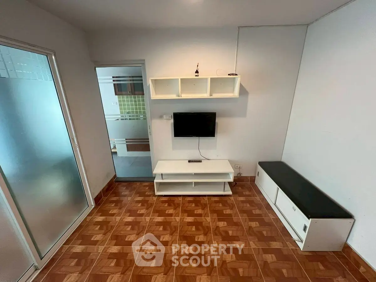 Cozy living room with modern TV setup and stylish tile flooring