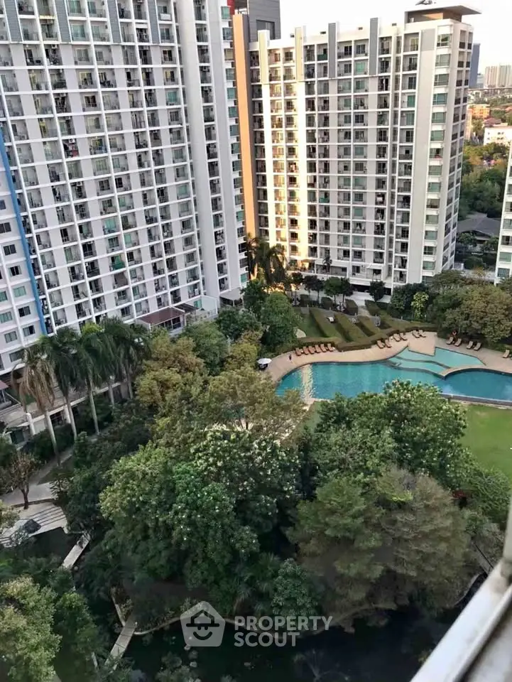 Luxurious high-rise apartment complex with stunning pool and lush gardens.