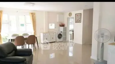 Spacious living room with modern furniture and natural light in a stylish home.