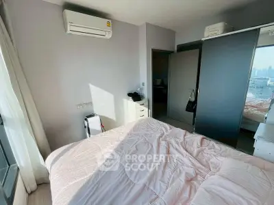 Bright bedroom with city view, air conditioning, and modern wardrobe.