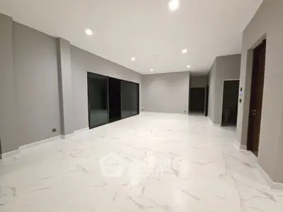 Spacious modern living room with marble flooring and large windows