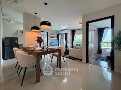 Modern open-plan living and dining area with stylish decor and natural light.