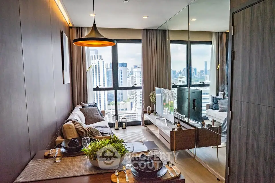 Modern living room with city view, stylish decor, and large windows in a high-rise apartment.