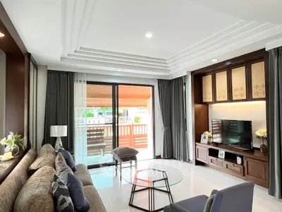 Elegant living room with modern decor and large sliding doors to balcony