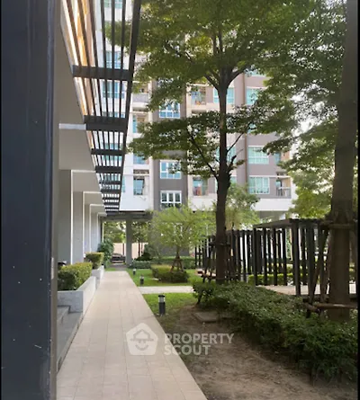 Modern apartment building with lush garden and walkway
