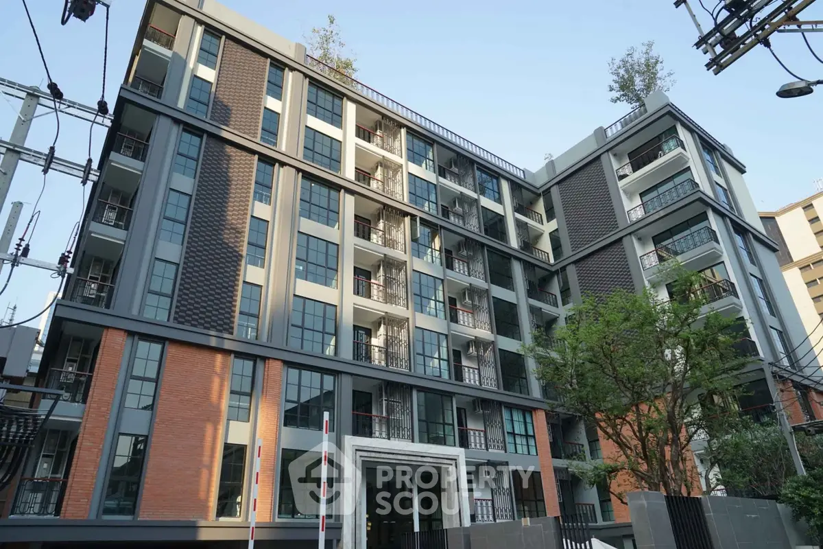 Modern urban apartment building with contemporary design and lush greenery