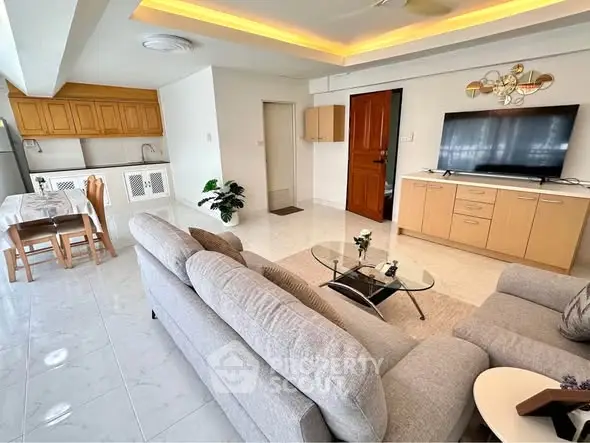 Spacious living room with modern decor and open kitchen layout