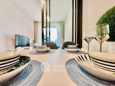 Elegant dining area with stylish table setting and modern decor in a bright, open living space.