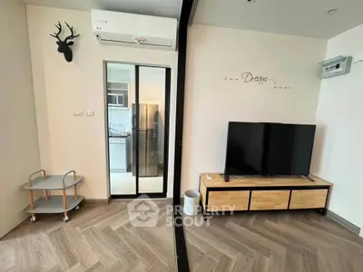 Modern living room with stylish decor and sliding glass door to kitchen