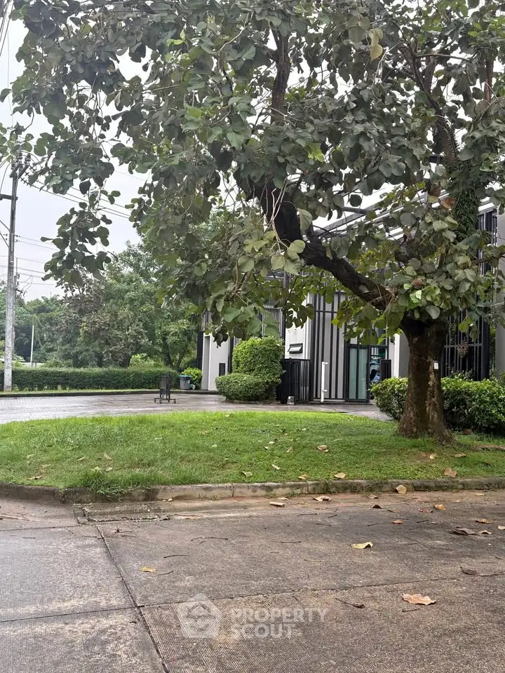 Charming residential building with lush greenery and serene surroundings.