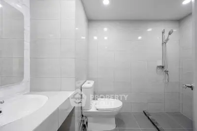 Modern bathroom with sleek tiles and a spacious shower area
