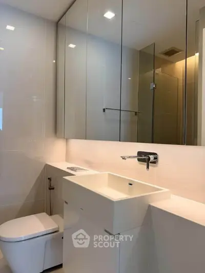 Modern bathroom with sleek fixtures and glass shower enclosure