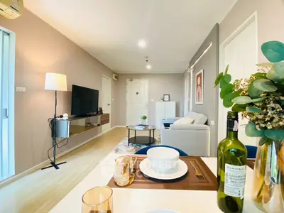 Modern living room with stylish decor and dining setup, perfect for cozy gatherings.