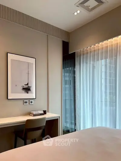 Modern bedroom with elegant decor and large window offering natural light and city view.