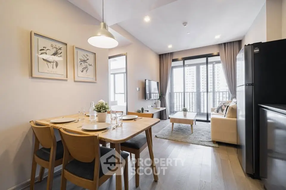 Modern open-plan living room with dining area and balcony view in a stylish apartment.