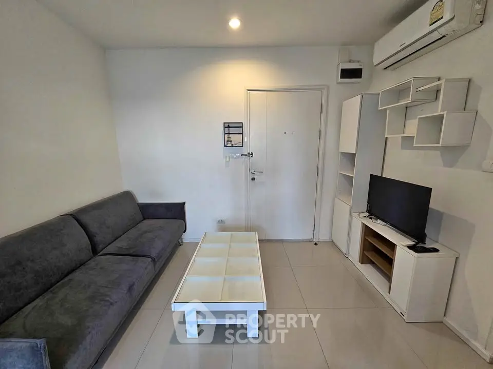 Modern living room with sleek furniture and air conditioning in a stylish apartment.