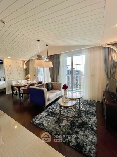 Luxurious open living room with elegant decor and city view, featuring plush seating and stylish lighting.