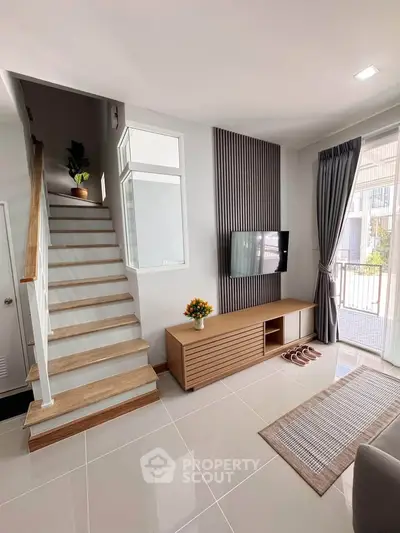 Modern living room with sleek staircase and stylish decor