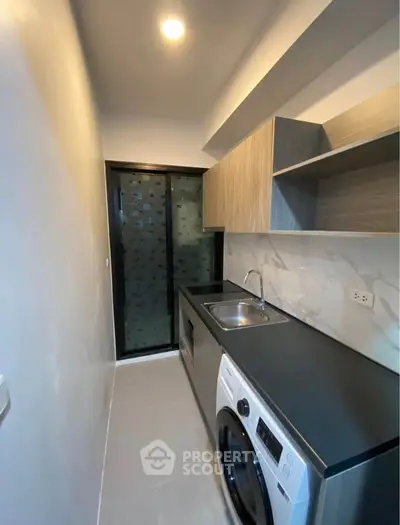 Modern kitchen with sleek design, featuring built-in appliances and stylish cabinetry.