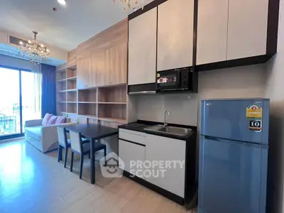 Modern open-layout kitchen with dining area and balcony view in stylish apartment.