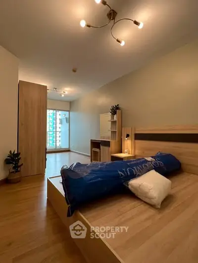 Spacious bedroom with modern wooden furniture and natural light