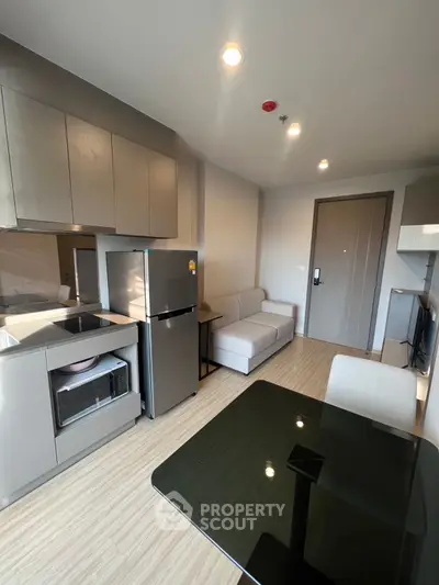 Modern compact living room with sleek kitchen and cozy sofa