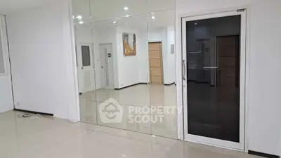 Spacious modern interior with mirrored wall and sleek flooring