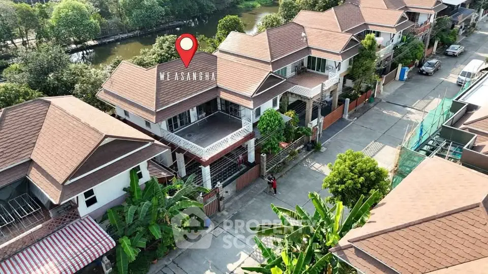 Charming suburban homes with lush greenery and serene water view