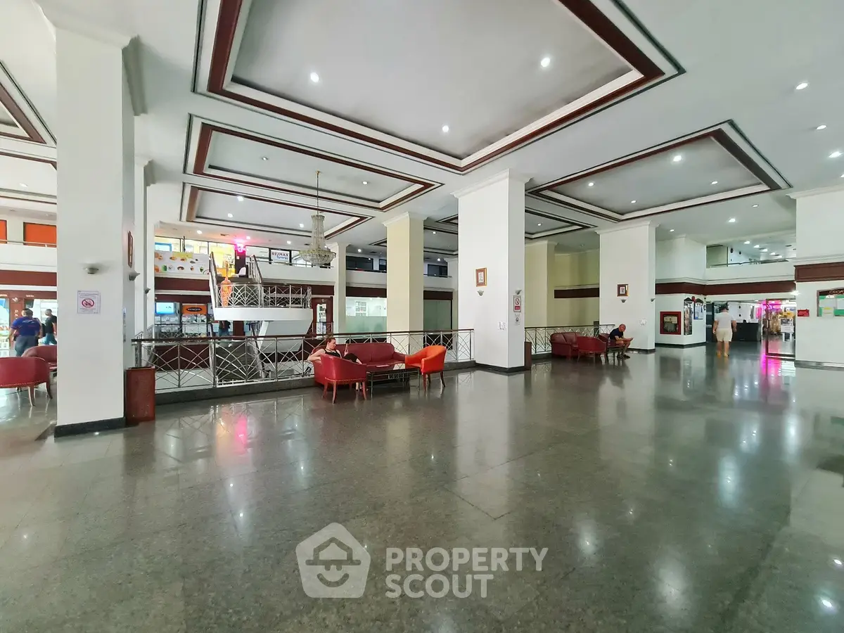 Spacious lobby area with modern seating and elegant ceiling design, ideal for welcoming guests in style.