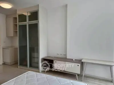 Modern bedroom with minimalist furniture and built-in storage, perfect for urban living.