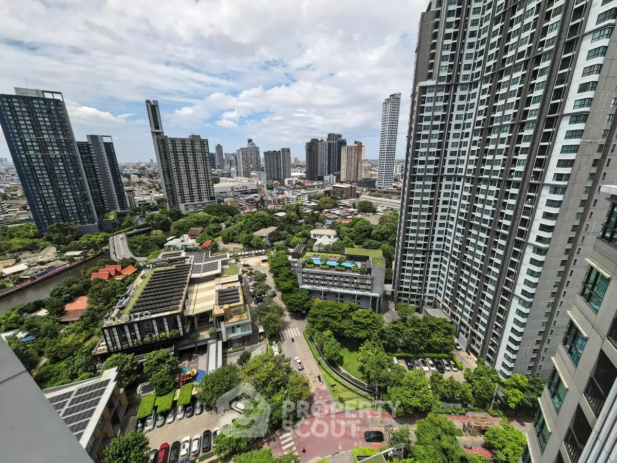 Stunning cityscape view from high-rise building with lush greenery and modern architecture.