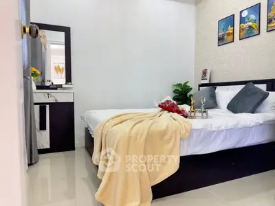 Cozy bedroom with modern decor and plush bedding in a stylish apartment.